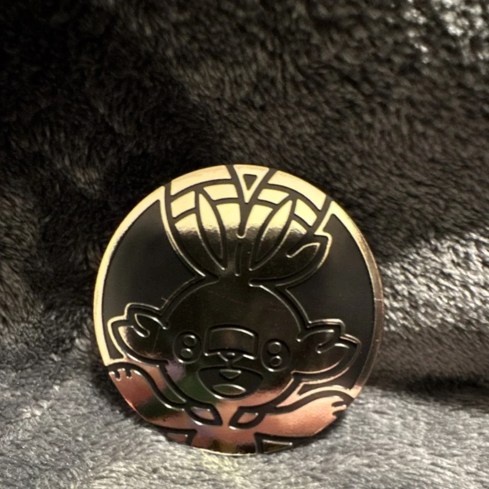 Nintendo Pokémon TCG Grookey Embossed Metal Flip Coin 1.2in Black/Gold/Copper